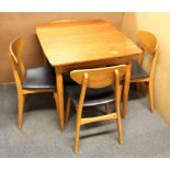 A 1960's dining table and four chairs, 91 x 76cm.