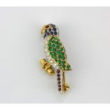 An 18ct yellow and white gold parrot shaped brooch set with emeralds, sapphires, rubies and