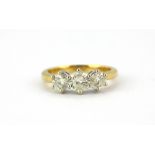 An 18ct yellow and white gold ring set with three brilliant cut diamonds, 1ct overall, (J.5).