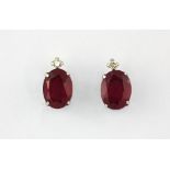 A pair of 18ct white gold (stamped 18k) ruby and diamond set stud earrings, L. 1cm.