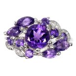 A 925 silver ring set with round cut amethysts and white stones, (O).