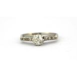 A platinum solitaire ring set with an old cut diamond and diamond set shoulders, approx. 0.33ct