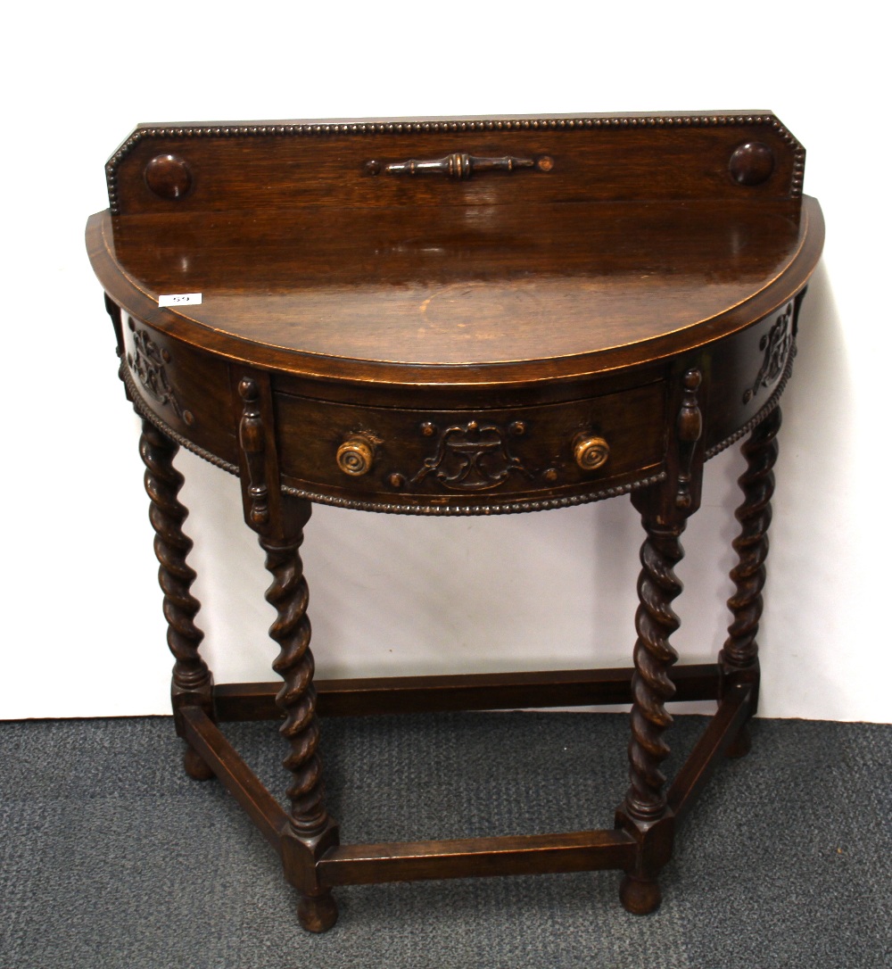 A carved oak console table with barley twist legs, W.76cm, H. 90cm.