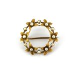 A 15ct yellow gold (stamped 15ct) pearl set brooch, in a bespoke box, Dia. 2.5cm.