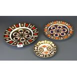 Three Royal Crown Derby porcelain plates, largest Dia. 27cm.