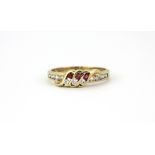 A 9ct yellow gold ruby and white stone set ring, (K.5).