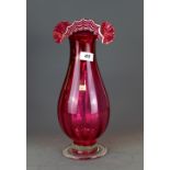A superb 19th Century cranberry glass vase with 'ribbon' style rim with white detail, H. 37cm.