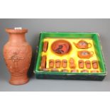 A boxed Japanese terracotta tea and sushi set together with a carved terracotta vase.
