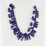 A lapis lazuli and pearl necklace, L. 46cm, together with another lapis lazuli necklace.