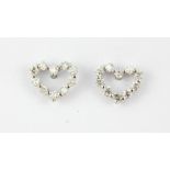 A pair of 18ct white gold diamond set heart shaped stud earrings, 0.6 x 0.8cm.