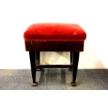 An adjustable mahogany piano stool.