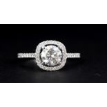 An 18ct white gold ring set with a brilliant cut 1.09ct diamond surrounded by brilliant cut