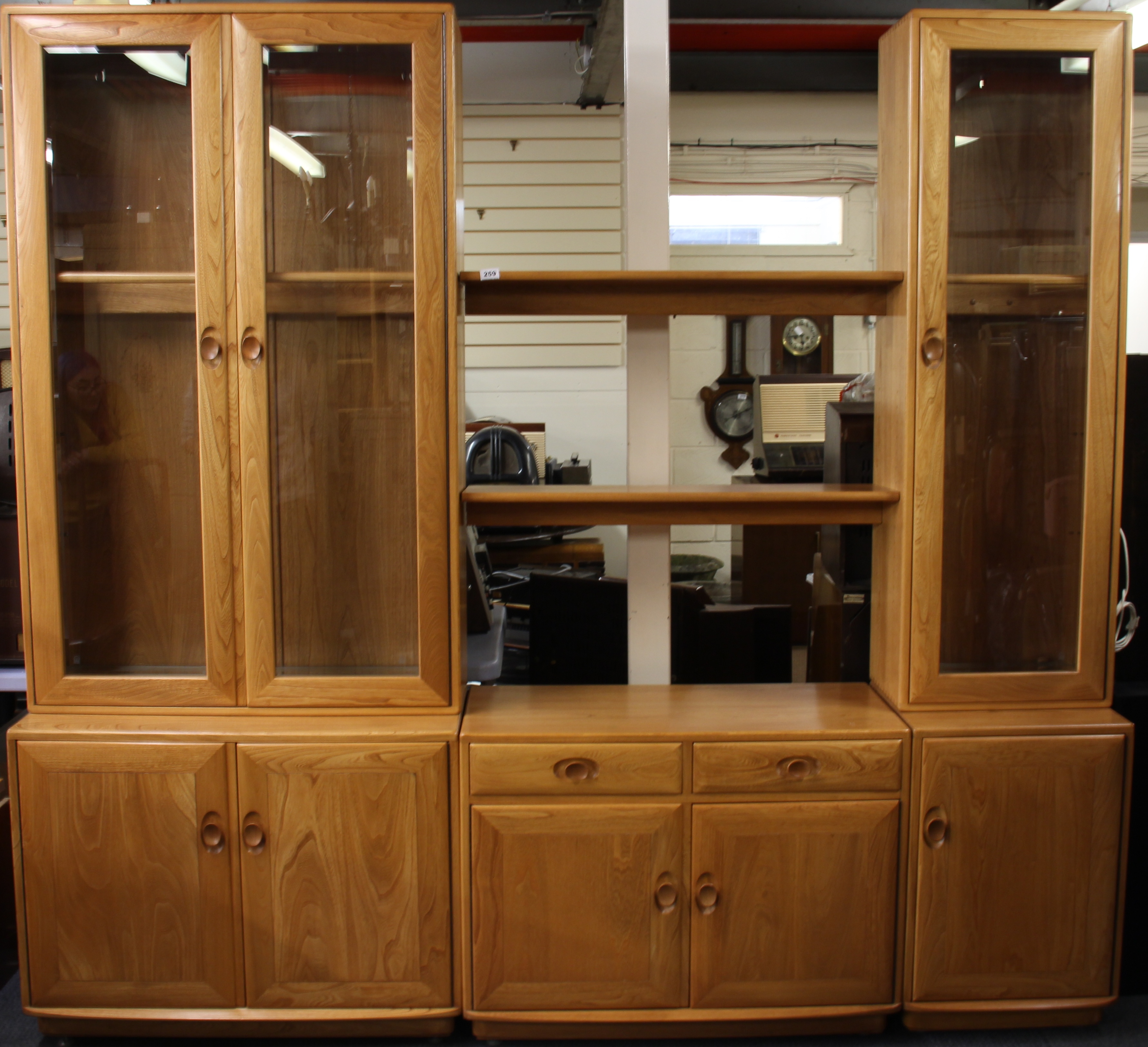 An Ercol three section glazed bookcase and display cabinet, overall W. 230cm H. 210cm.