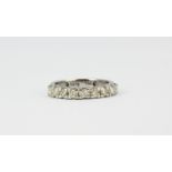 An 18ct white gold diamond set half eternity ring, (O).