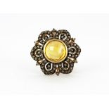 A 9ct yellow gold flower shaped ring set with a faceted cut citrine and brilliant cut fancy yellow