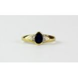 A 9ct yellow gold ring set with an oval cut blue stone and diamond set shoulders, (K).