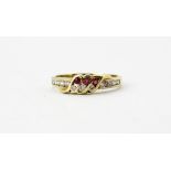 A 9ct yellow gold ruby and white stone set ring, (K.5).