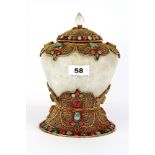 A Tibetan rock crystal and gilt filigree mounted offering jar and cover, inset with red and green