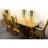 A lovely Ercol extending light oak dining table with six chairs all with engraved wheatsheaf pattern