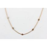 An 18ct rose gold (stamped 750) brilliant cut diamond set chain, L. 42cm.