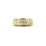 An 18ct yellow gold (stamped 750) ring set with two rows of brilliant cut diamonds, (L).