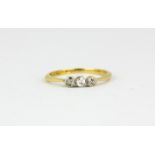 An 18ct yellow gold ring set with three old cut diamonds, (M).