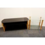 A contemporary black glass and wood tv stand, W. 135cm H. 51cm, together with a further wood and