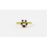 An early 20th century 18ct yellow gold diamond and sapphire set horseshoe shaped ring, (P).