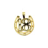 A 9ct yellow gold "18" pendant, L. 2.5cm.