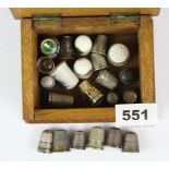 An oak box of thimbles including, three 925 silver and one sterling silver.