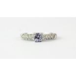 A 9ct white gold stone set ring, (P).