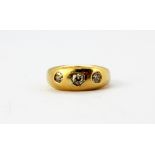 A gentleman's 18ct yellow gold gypsy ring set with three old cut diamonds, (M).