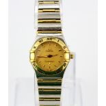 An Omega Constellation 18ct yellow gold and stainless steel lady's wrist watch.