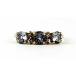 A 9ct yellow gold ring set with iolites, (N.5).