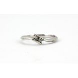A 9ct white gold diamond set crossover ring, (N).
