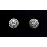 A pair of 18ct white gold brilliant cut diamond set halo earrings, approx. 1ct overall, Dia. 0.8cm.