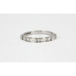An 18ct white gold ring set with baguette and brilliant cut diamonds, (M).