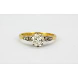 An 18ct yellow gold and platinum solitaire ring set with an old cut diamond and diamond set