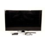 A Samsung 65" SUHD curved television with Freeview HD and built-in Wi-Fi and remote control.