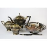 A three piece 1920's Chinese silver tea set with matching sugar tongs stamped to the base