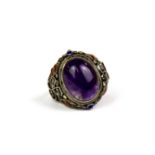 A Chinese enamelled silver and amethyst ring (adjustable size).