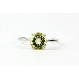 A 9ct white gold solitaire ring set with a round cut citrine, (P).