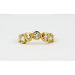 An 18ct yellow gold ring set with five brilliant cut diamonds, (P).