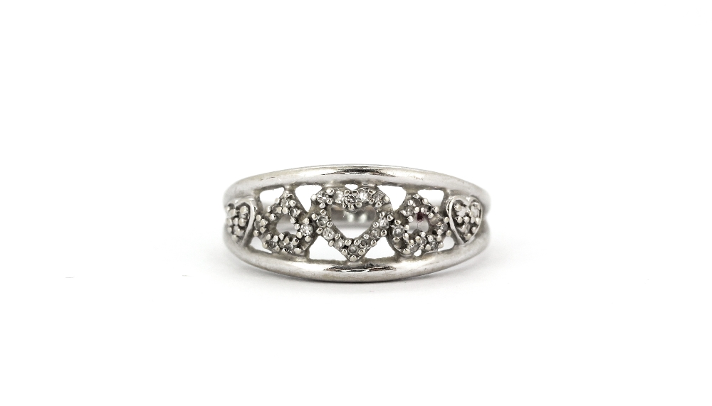 A 9ct white gold (stamped 10k) diamond set hearts ring, (M).