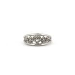 A 9ct white gold (stamped 10k) diamond set hearts ring, (M).
