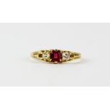 A yellow metal (tested 18ct gold) ring set with a red stone flanked by old cut diamonds, (P.5).