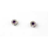 A pair of 9ct yellow gold amethyst and diamond set stud earrings, Dia. 0.6cm.