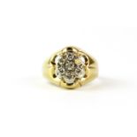 A 14ct yellow gold (stamped 14k) diamond set daisy cluster ring, (P).