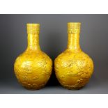 A pair of impressive Chinese relief decorated and Imperial yellow glazed porcelain vases, H. 38cm.