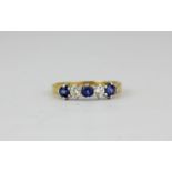 An 18ct yellow and white gold sapphire and diamond set half eternity ring, (L.5).